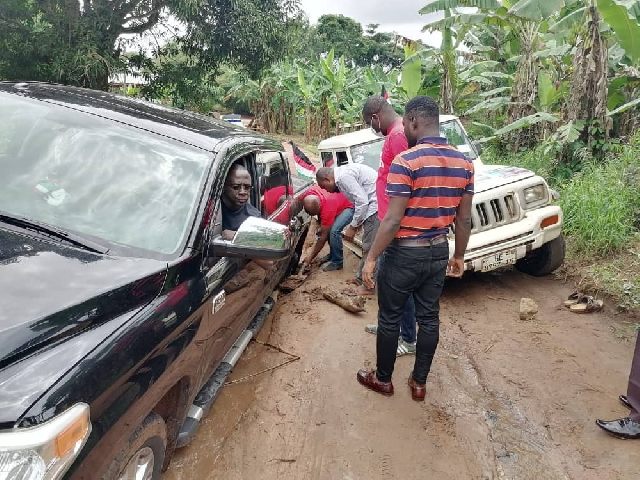 Mr Kofi Awuah's car stuck on the muddy stretch